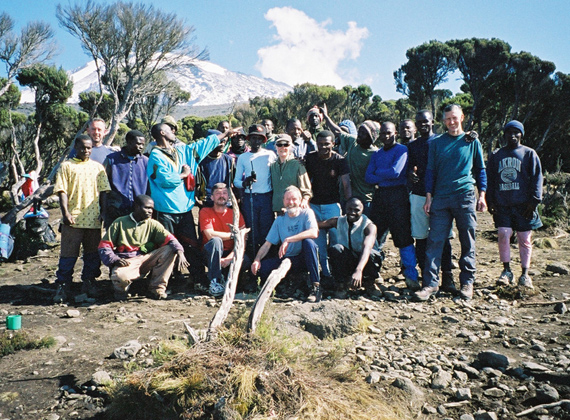 Group of trekkers and porters at Mount Kilimanjaro